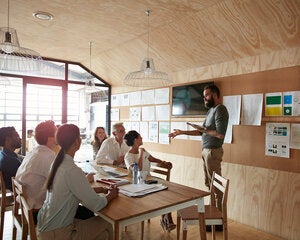 A lecturer speaks to a class of design students
