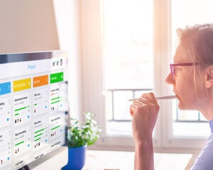 Woman at desk looking at computer screen