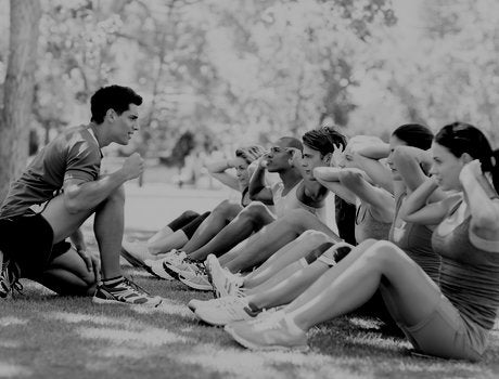 fitness instructor with group of people exercising