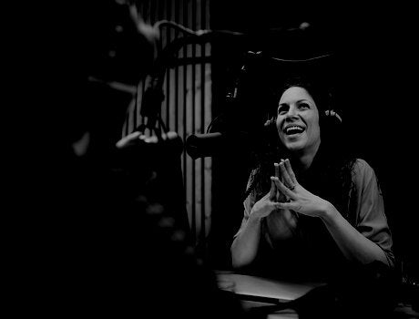 Woman smiling during podcast recording