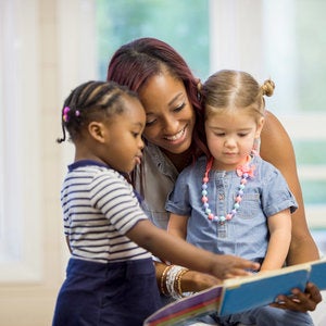 teacher reading with young students