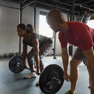 Two people doing dead lifts