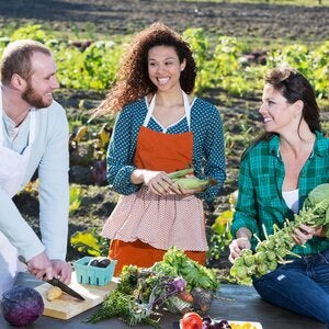 man and two women planting food in a field