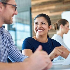 two professionals looking at a paper document