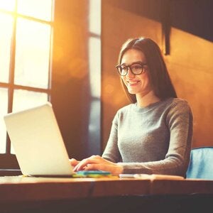 woman using laptop in cafe