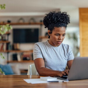 individual with glasses at laptop