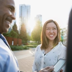 Asian American female smiling as the sun just barely touches her face