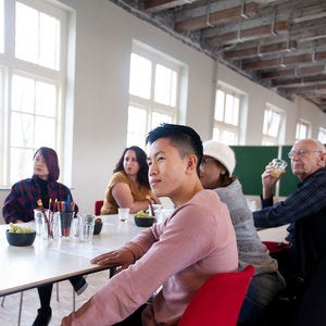 writing students sitting at a long table