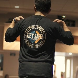 Get Safe logo on the back of a t-shirt worn by a Get Safe Instructor