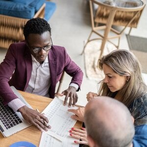 accountant working with two clients at a table