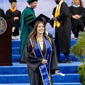 graduate smiling after walking off the stage