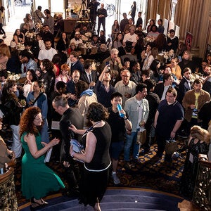 crowd of UCLAx FilmFest goers on the grand stair case at the Los Angeles Theatre