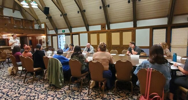 UCLA Lake Arrowhead Lodge writers retreat discussion at a conference table
