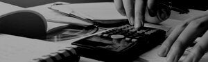 Woman using calculator with doing finance at home office.