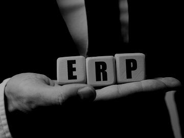 Man holding blocks that spell out ERP