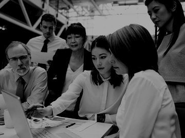 Accountants reviewing a colleague's laptop screen