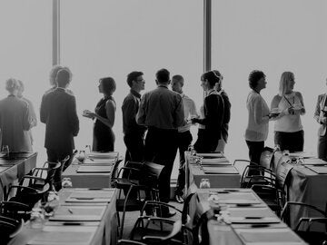 Men and women talking at a human resources workshop.