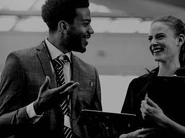 man and woman talking in office