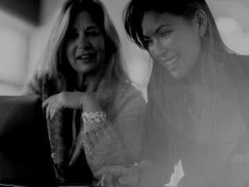two women looking at computer