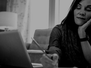 Woman with purple scarf working on screenplay