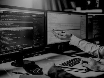 hand pointing to html and css code on screen
