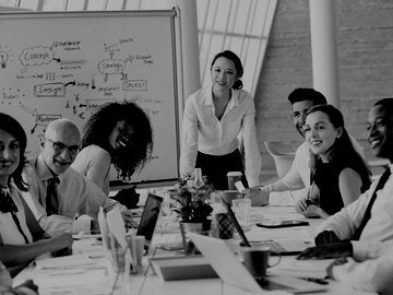 Asian Businesswoman Leading Meeting At Boardroom Table