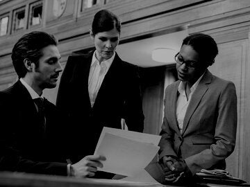 three lawyers reviewing legal documents