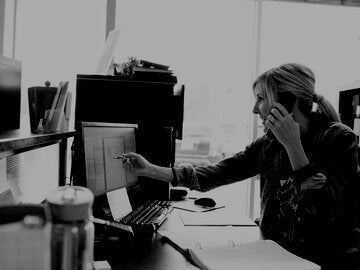 Accounting reviewing digital invoice while on phone