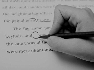 Copywriter noting corrections on a document.