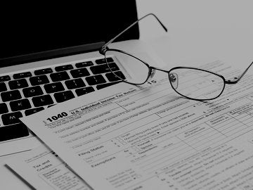 U.S. 1040 income tax return form with laptop and glasses