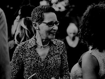 Smiling woman in discussion with another woman