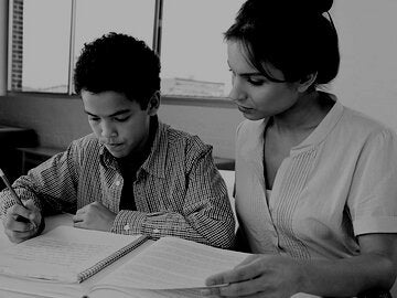 Woman mentoring boy student