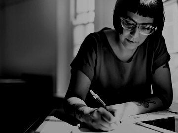 woman writing on paper