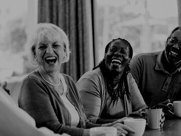 two senior couples at a table drinking coffee