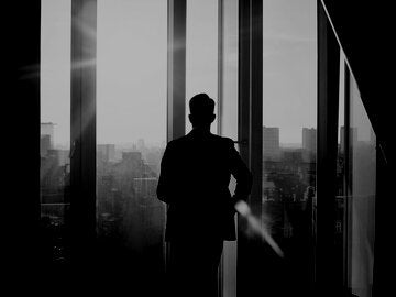 Business man walking toward the light