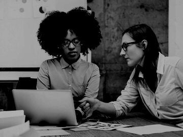 Two young women having a discussion in a business 