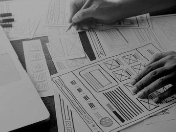 Person drawing out wireframes for a website