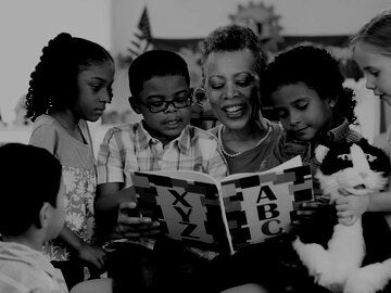 Kindergarten teacher reading to class