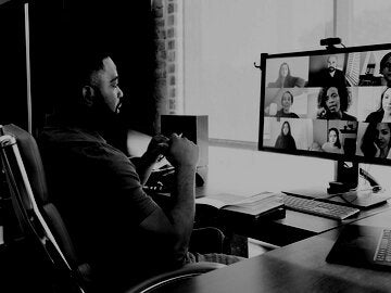 Mid adult manager video conferences with his team