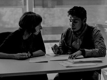 Counseling appointment for young latino man student in counsellor College office.
