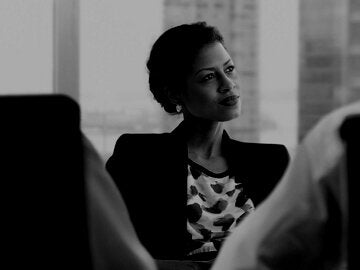 business woman in a suit at a conference table