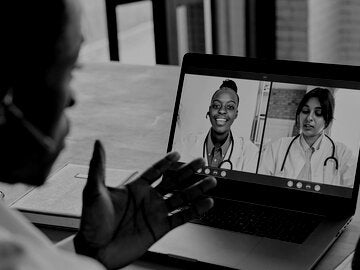 Multicultural doctors team conferencing in video call chat discussing health care learning online during web seminar.