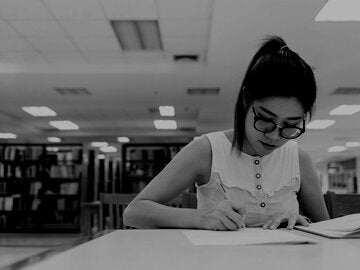 woman writing on a paper