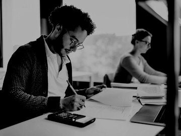Young Student Concentrating While Studying In Public Library