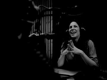 Woman smiling during podcast recording