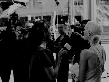 Reporter speaking to celebrity on red carpet