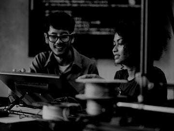 man and woman looking at a screen