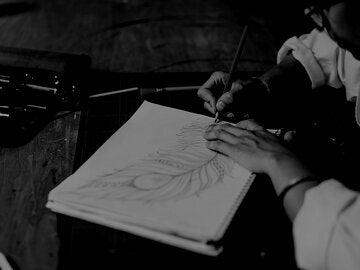 woman drawing a feather