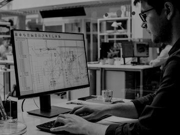 Over the Shoulder Shot of Engineer Working with CAD Software on Desktop Computer