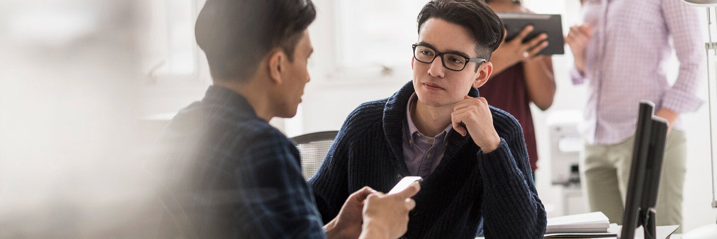 Social media managers reviewing social media on iphone and tablet.